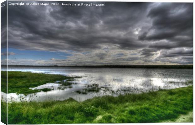 Dark Clouds reflecting in Marshes Canvas Print by Zahra Majid