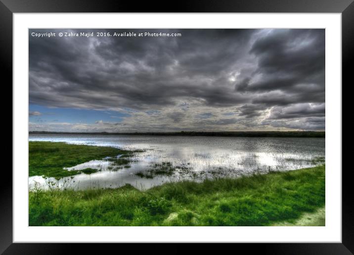 Dark Clouds reflecting in Marshes Framed Mounted Print by Zahra Majid