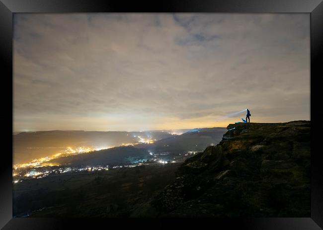 Male and his dog, standing on Curbar Edge at night Framed Print by Liam Grant