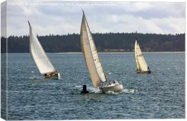 A sailing yacht rounds a buoy in a close sailing r Canvas Print by Louise Heusinkveld