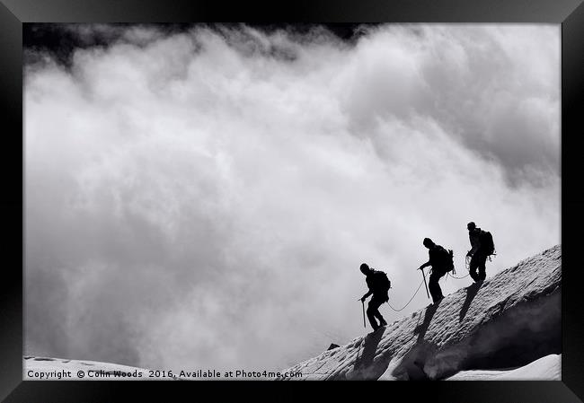 Climbers descending into the clouds Framed Print by Colin Woods