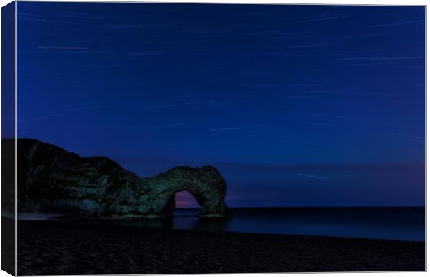 Star Trails above Durdle Door Canvas Print by Anthony Simpson