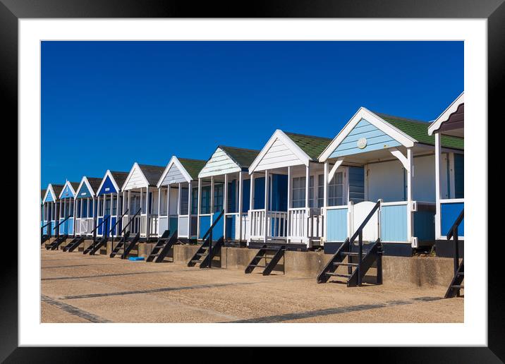 Beach huts in blue and white Framed Mounted Print by Kevin Snelling
