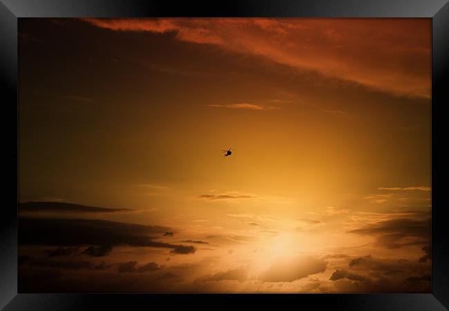 Helicopter at sunset Framed Print by Ian Jeffrey