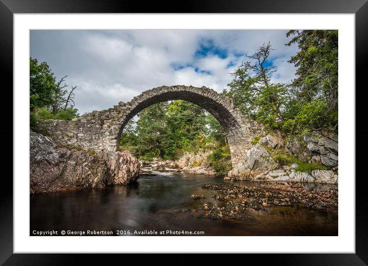 Old stone bridge in the village of Carrbridge Framed Mounted Print by George Robertson
