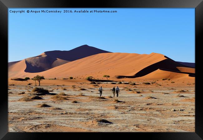 Figures in a desert landscape Framed Print by Angus McComiskey