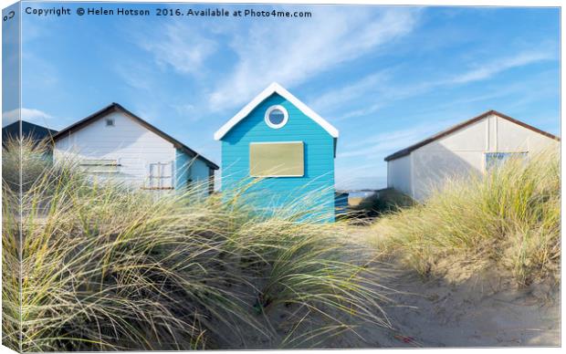 Blue & White Beach Huts Canvas Print by Helen Hotson