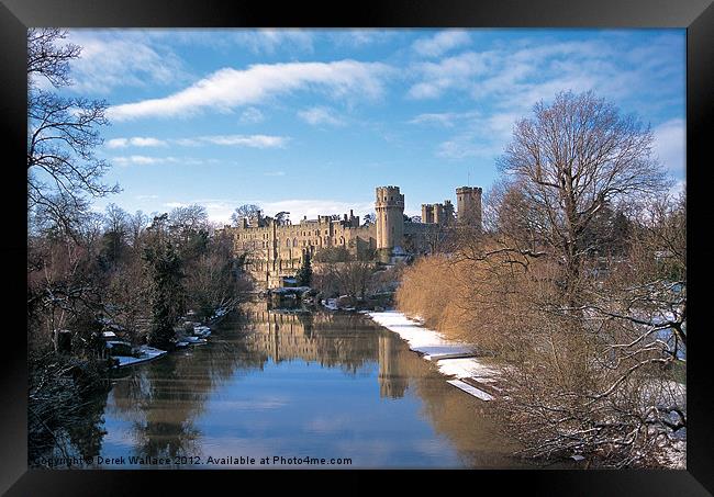 Warwick Castle in the snow Framed Print by Derek Wallace