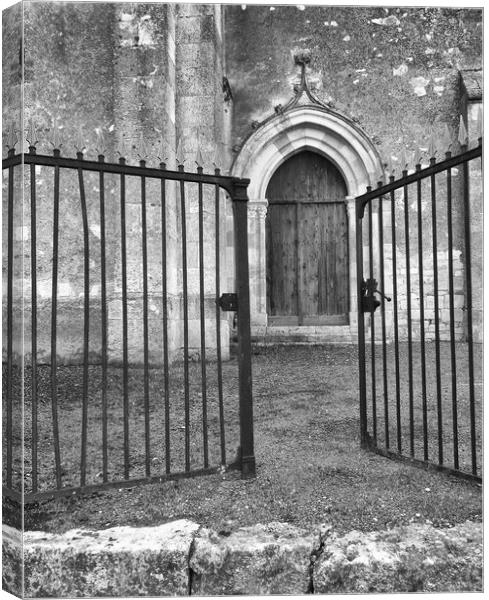 Church door through the gates Canvas Print by Peter Balfour