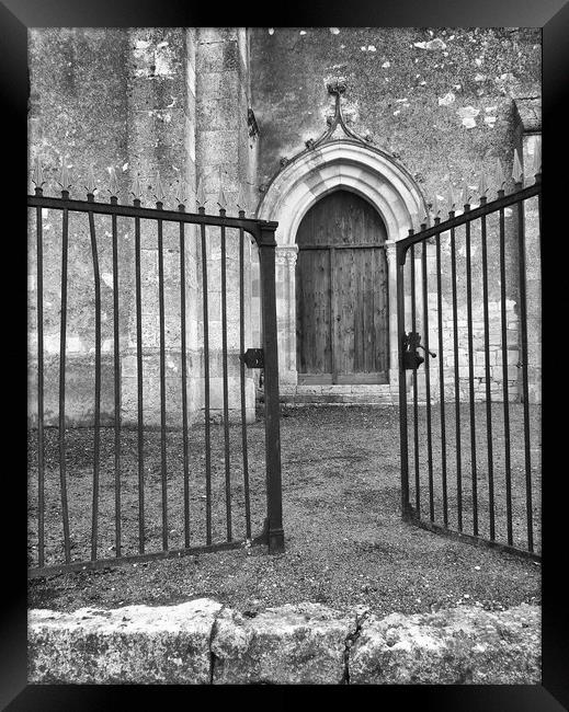 Church door through the gates Framed Print by Peter Balfour