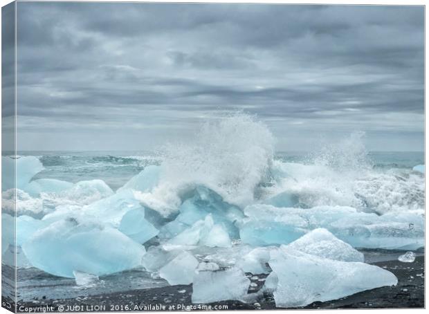 Waves breaking over blocks of ice Canvas Print by JUDI LION