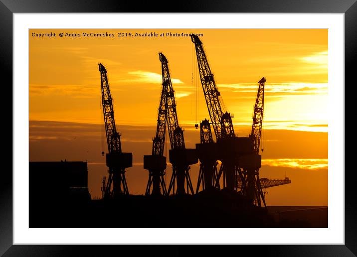 Cranes on the River Clyde at sunset Framed Mounted Print by Angus McComiskey