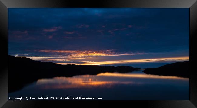 Reflections of a Highland sunset Framed Print by Tom Dolezal