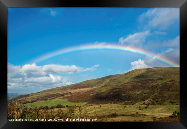 Rainbow over blue sky in the Brecon Beacons Framed Print by Nick Jenkins