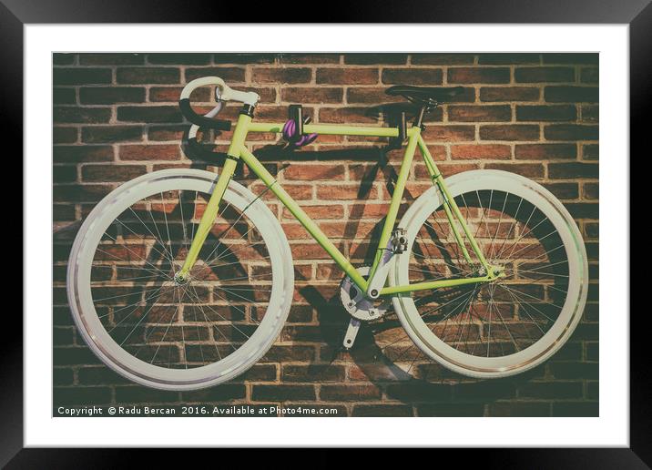 Bike Hanged On Brick Wall Framed Mounted Print by Radu Bercan