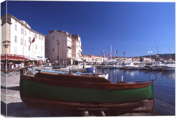 Green boat under dramatic sunny noon in St. Tropez Canvas Print by Alfredo Bustos