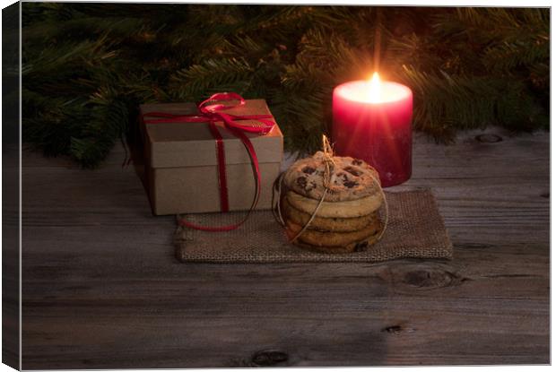 Neatly tied fresh cookies with warm glowing candle Canvas Print by Thomas Baker