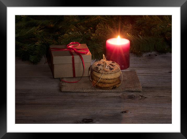 Neatly tied fresh cookies with warm glowing candle Framed Mounted Print by Thomas Baker
