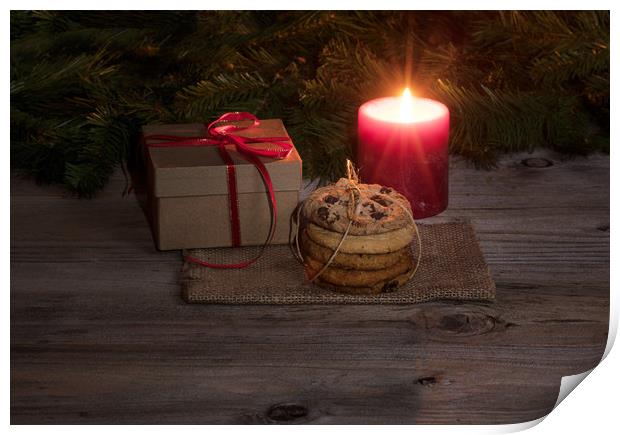 Neatly tied fresh cookies with warm glowing candle Print by Thomas Baker