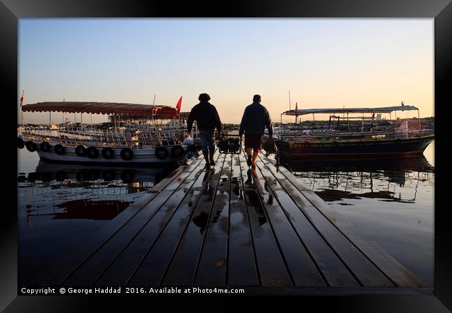 Loading the Boat. Framed Print by George Haddad