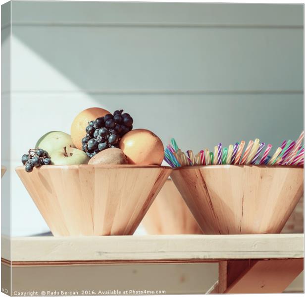 Fruit Bowl And Colorful Straws On Table Canvas Print by Radu Bercan