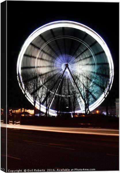 Ferris wheel in motion Canvas Print by Gwil Roberts