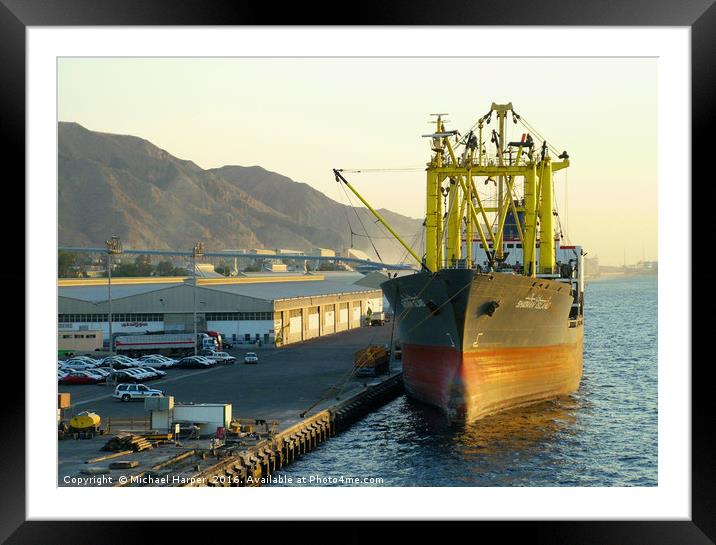 Vessel lies at dock waiting to be unloaded. The ea Framed Mounted Print by Michael Harper