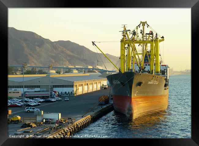 Vessel lies at dock waiting to be unloaded. The ea Framed Print by Michael Harper