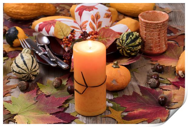 Holiday candle glowing for dinner setting for fall Print by Thomas Baker