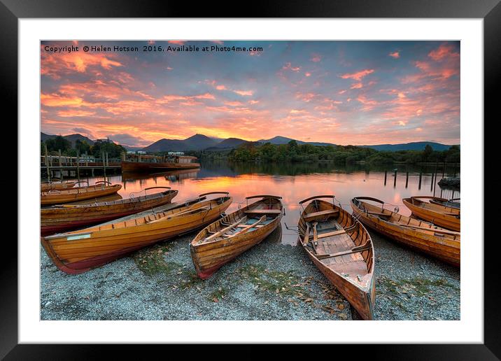 Stunning sunset over wooden rowing boats on Derwen Framed Mounted Print by Helen Hotson