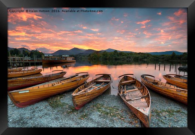 Stunning sunset over wooden rowing boats on Derwen Framed Print by Helen Hotson