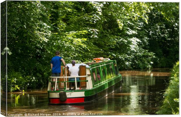 Couple steering a canal boat down the Brecon Canal Canvas Print by Richard Morgan