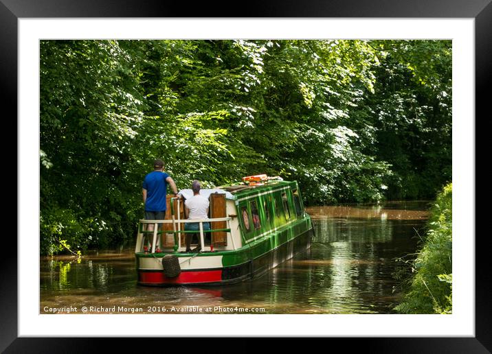 Couple steering a canal boat down the Brecon Canal Framed Mounted Print by Richard Morgan