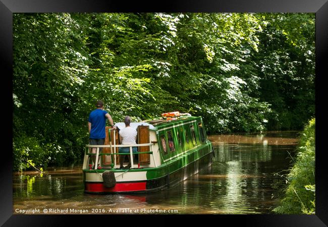Couple steering a canal boat down the Brecon Canal Framed Print by Richard Morgan