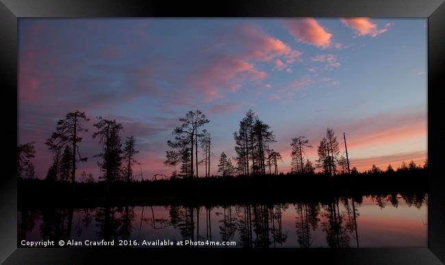 Sunset over the forest in Finland Framed Print by Alan Crawford