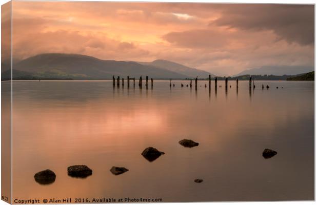 Loch Lomond jetty and mountains at sunset Canvas Print by Alan Hill