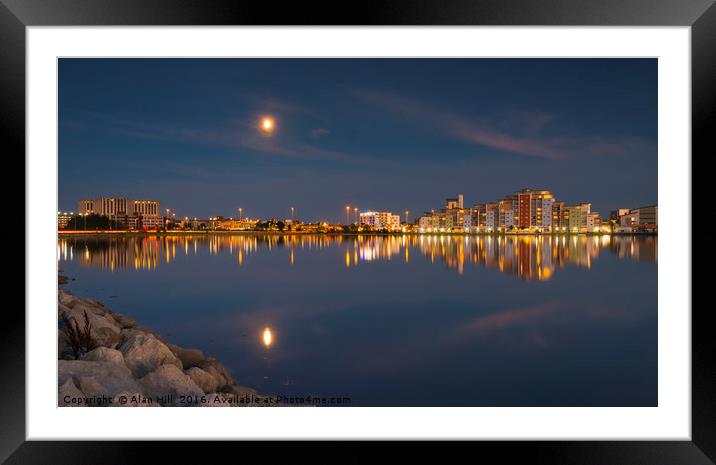 The moon and cityscape lights, reflect off harbour Framed Mounted Print by Alan Hill