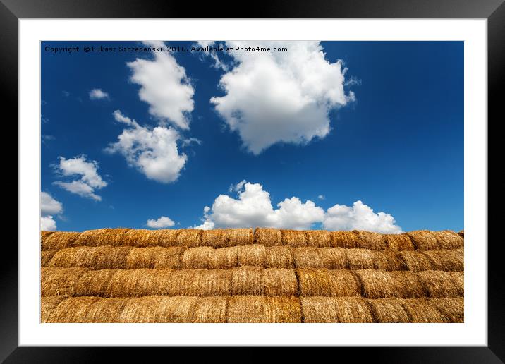 Bales of straw under blue cloudy sky Framed Mounted Print by Łukasz Szczepański