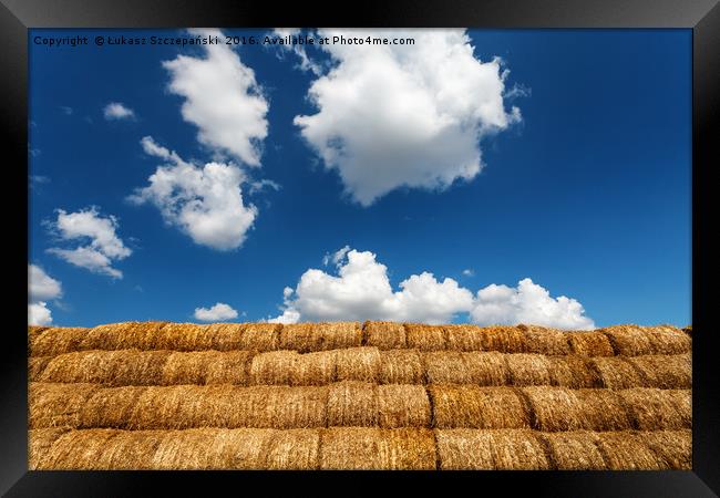 Bales of straw under blue cloudy sky Framed Print by Łukasz Szczepański
