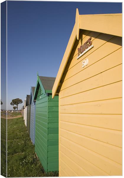 Colourful beach huts in Calshot. Canvas Print by Ian Middleton
