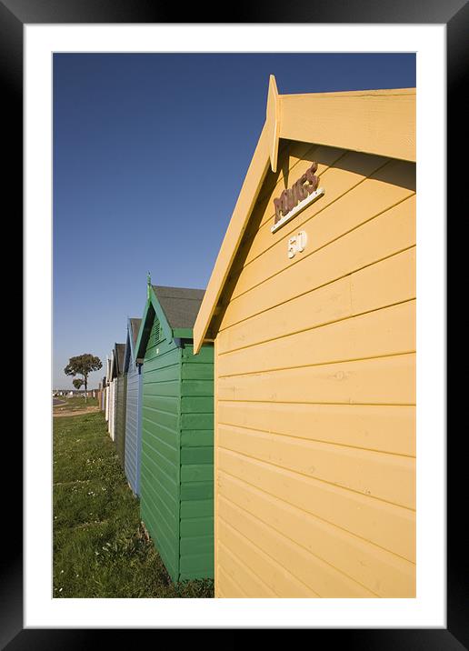 Colourful beach huts in Calshot. Framed Mounted Print by Ian Middleton