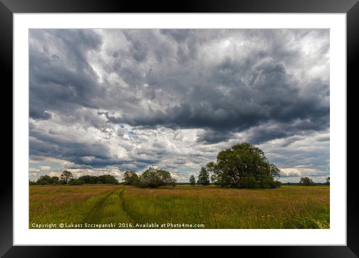 Stormy cloudscape over meadow Framed Mounted Print by Łukasz Szczepański