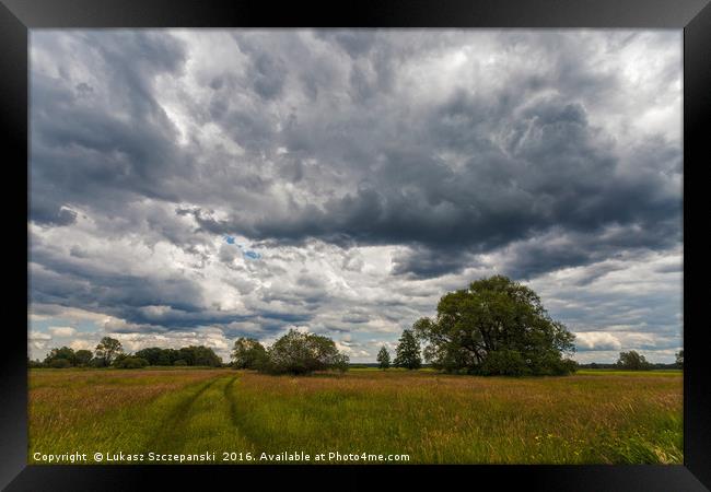 Stormy cloudscape over meadow Framed Print by Łukasz Szczepański