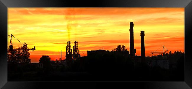 Smoking factory chimnies at sunset Framed Print by Ray Fidler