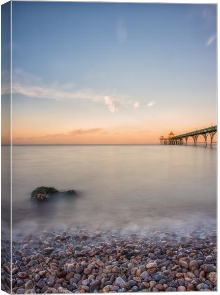 Pebbles and Pier Canvas Print by Chris Sweet