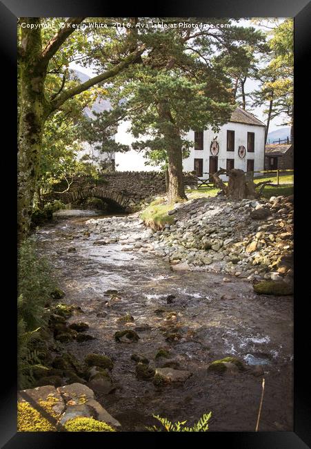 Cottage by stream Framed Print by Kevin White