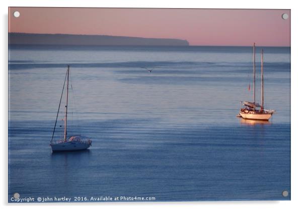 Pink Sky Sunrise flooding over boats on a calm blu Acrylic by john hartley