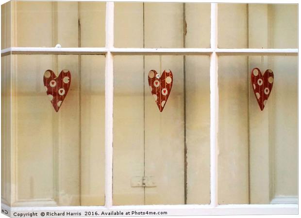 Decorative hearts displayed inside shuttered windo Canvas Print by Richard Harris