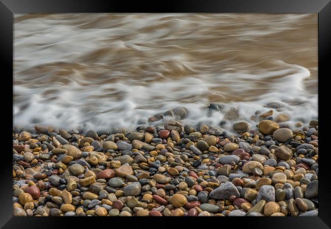 Pebbles on the beach. Framed Print by Bryn Morgan
