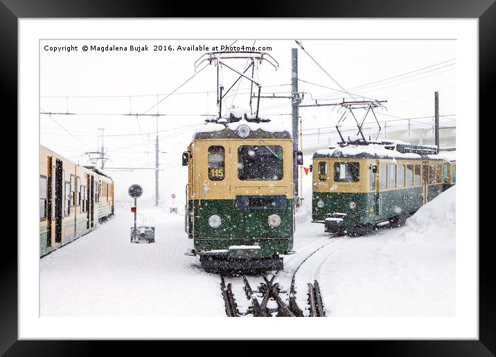 Trains in heavy snow at Kleine Scheidegg station Framed Mounted Print by Magdalena Bujak